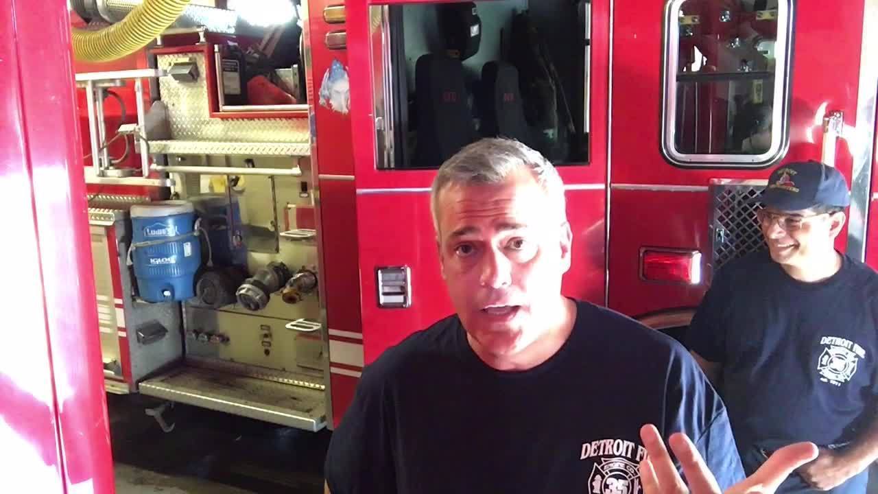 Shawn Ley tries on fire gear in 90 degree heat